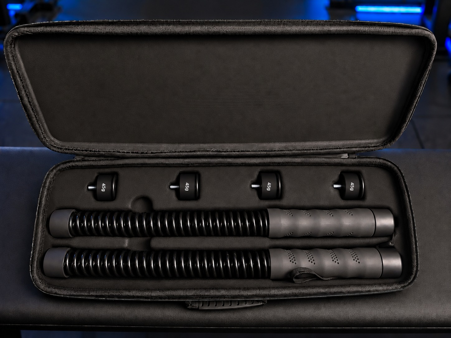 VYLARO carrying case open, showing two ropeless battle ropes and four 45g weight blocks